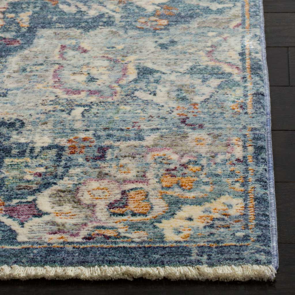 A blue and cream floral border is framed by fine binding and a short fringed edge.