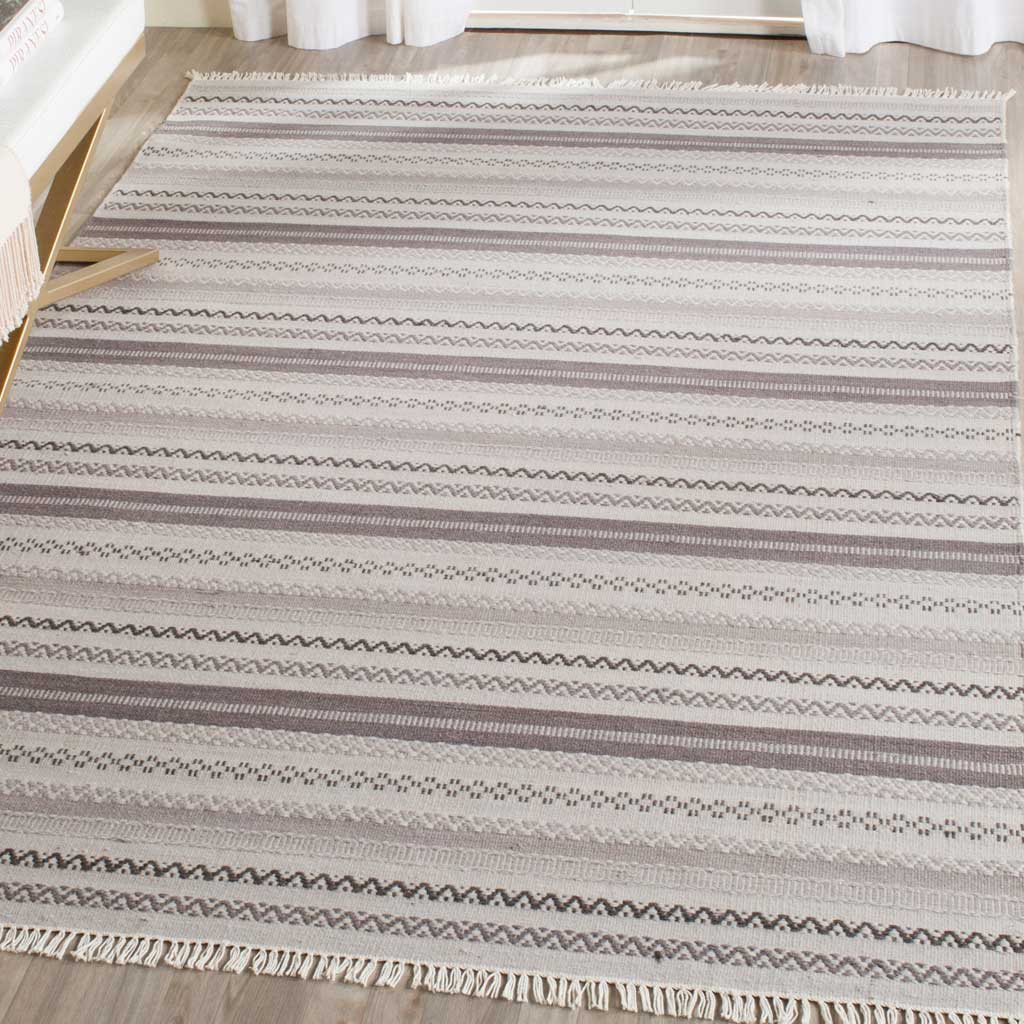 Layered gray and ivory geometric bands lend a calm, textured foundation to a living space