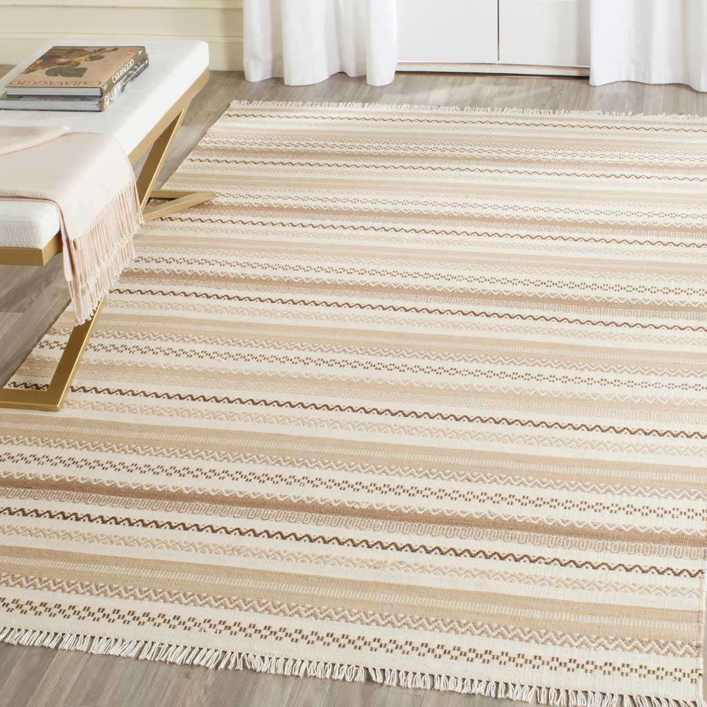 Beige and ivory patterned bands and soft fringe bring inviting texture alongside modern furnishings