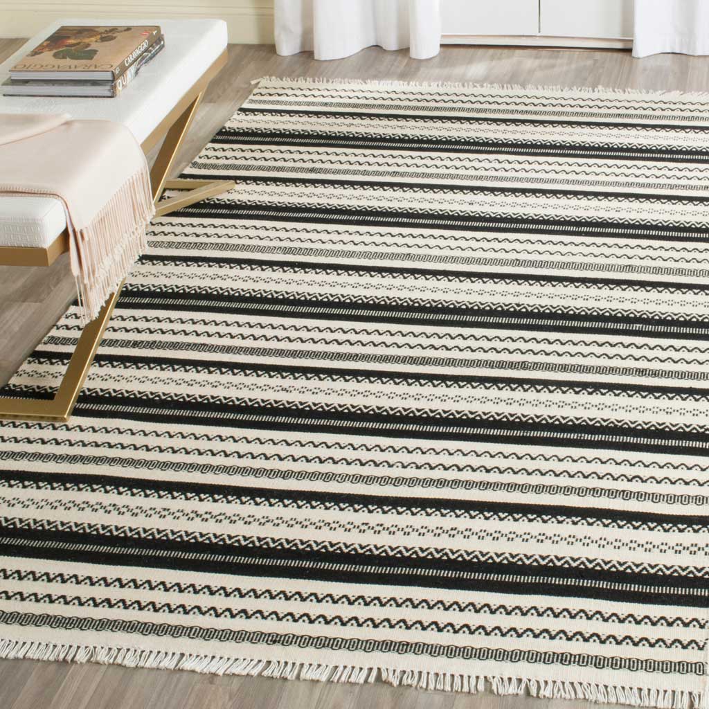 Black and ivory patterned stripes bring graphic contrast and cozy texture to a modern living area