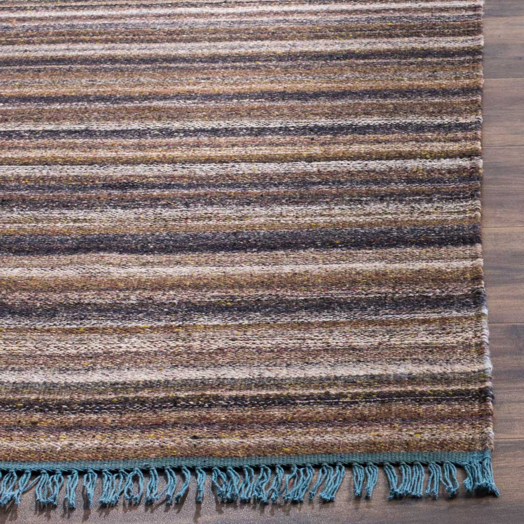 Dense gray and purple stripes meet a blue bound edge and loose woven fringe
