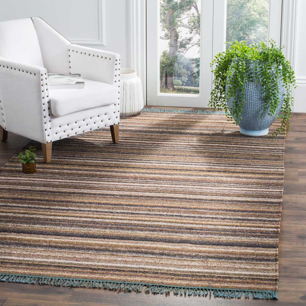 Muted gray and violet stripes add quiet depth underfoot, finished with soft blue fringe