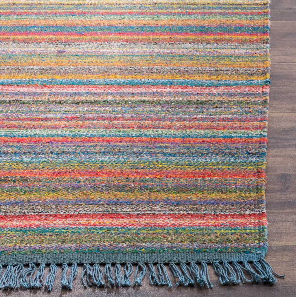 Vibrant stripes in blue, orange, and red meet a textured edge with loose blue fringe