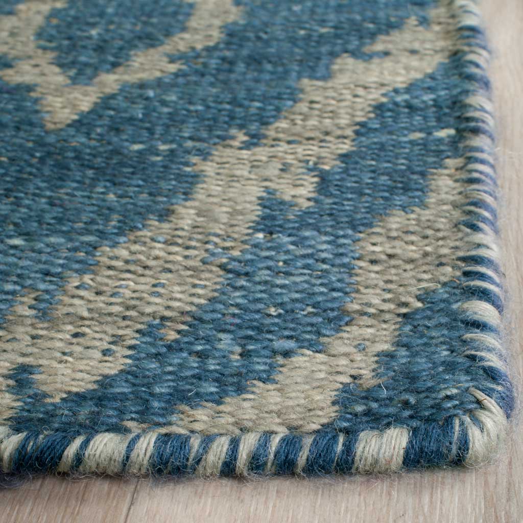 Blue and gray wool yarns form a dense weave with a neatly wrapped edge.