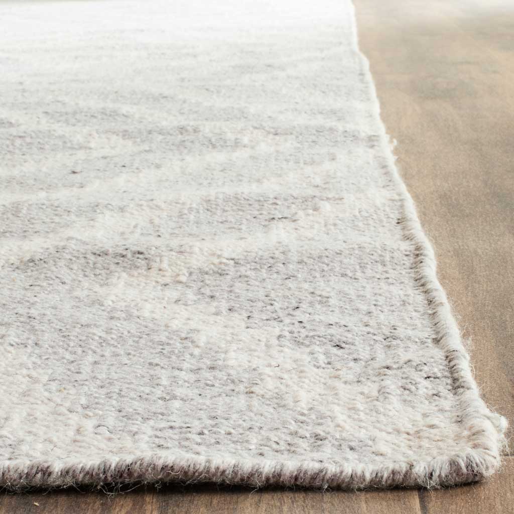 Silver and ivory rug with a textured weave and neatly finished edges