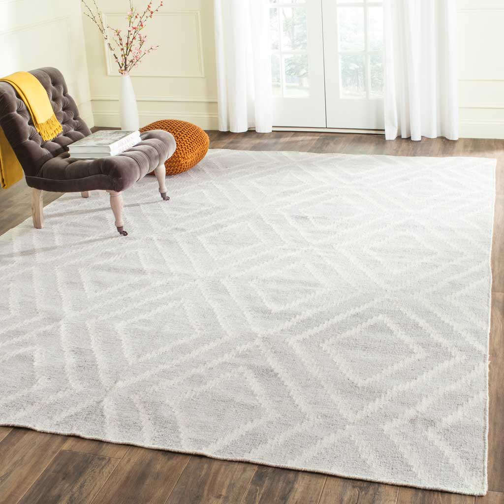 Silver and ivory diamond rug adds a soft geometric layer to a bright room