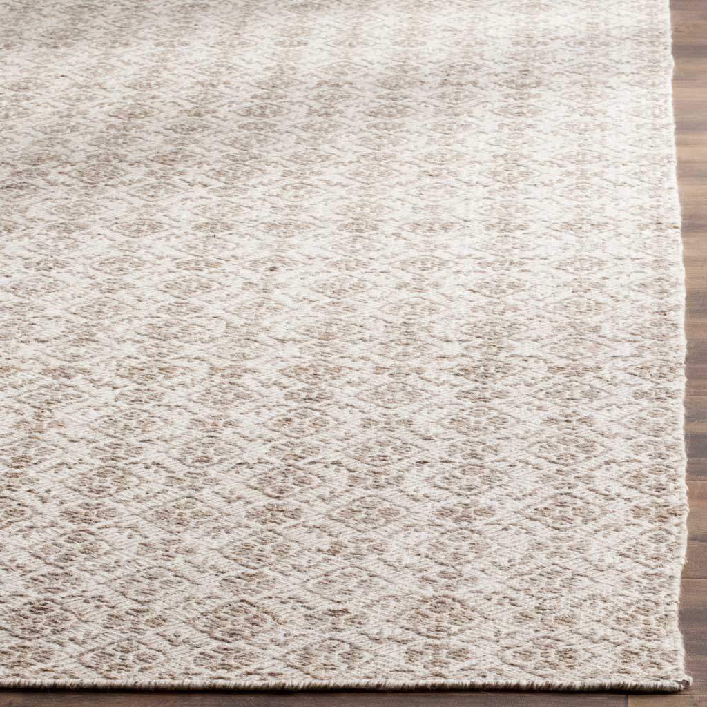 Textured wool fibers define the gray and ivory diamond pattern and neatly finished edge