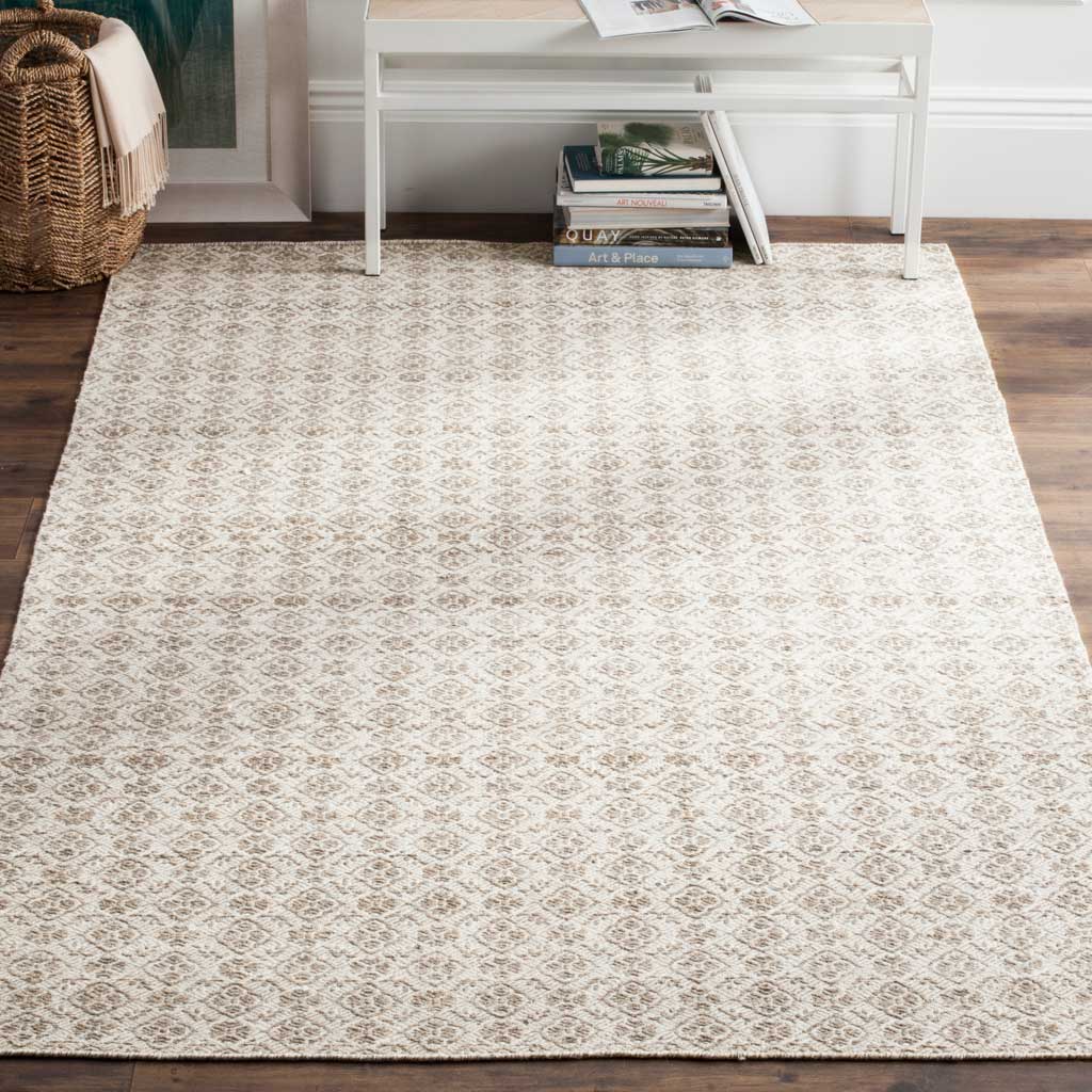 A softly faded diamond pattern gives this gray and ivory wool rug understated traditional charm