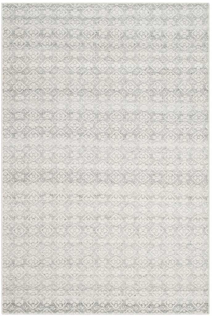 A light ivory rug with muted silver motifs brings fine detail to a handwoven wool surface
