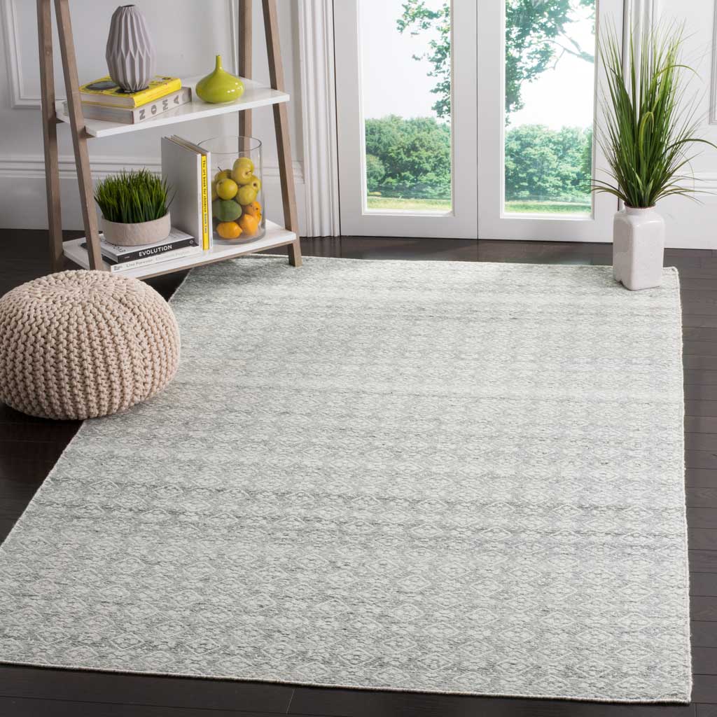Fine silver diamonds give this ivory wool rug an airy, gently layered look