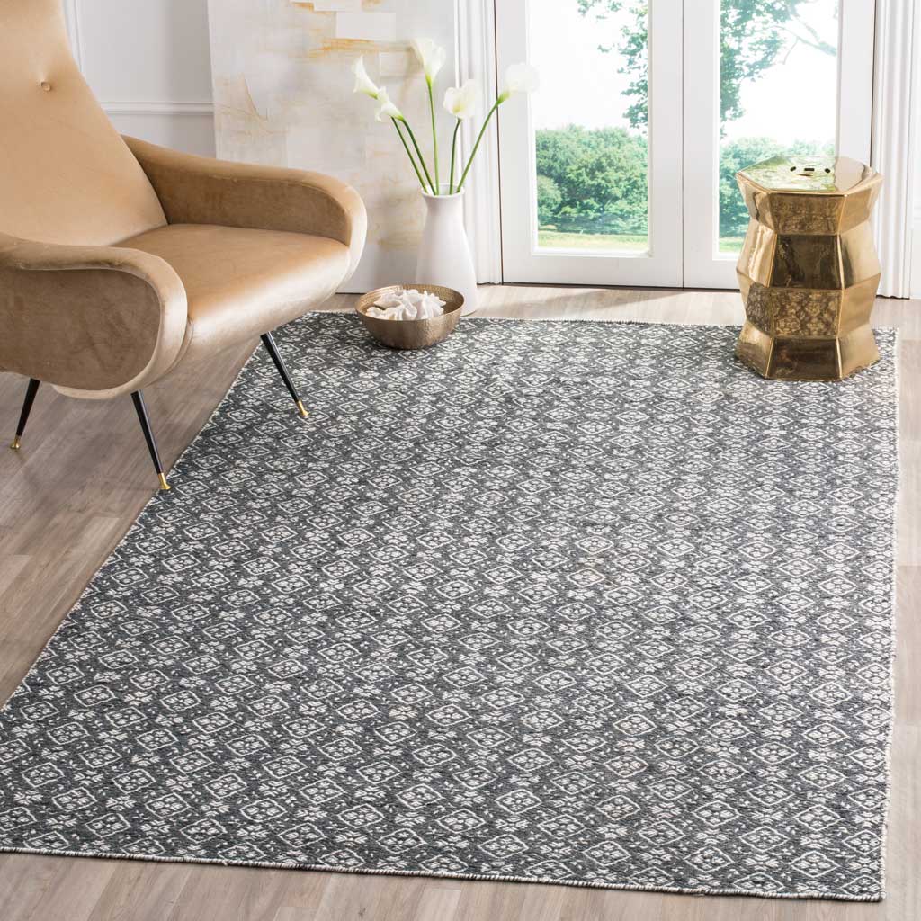 Graphic ivory diamonds bring lively contrast to this charcoal wool rug