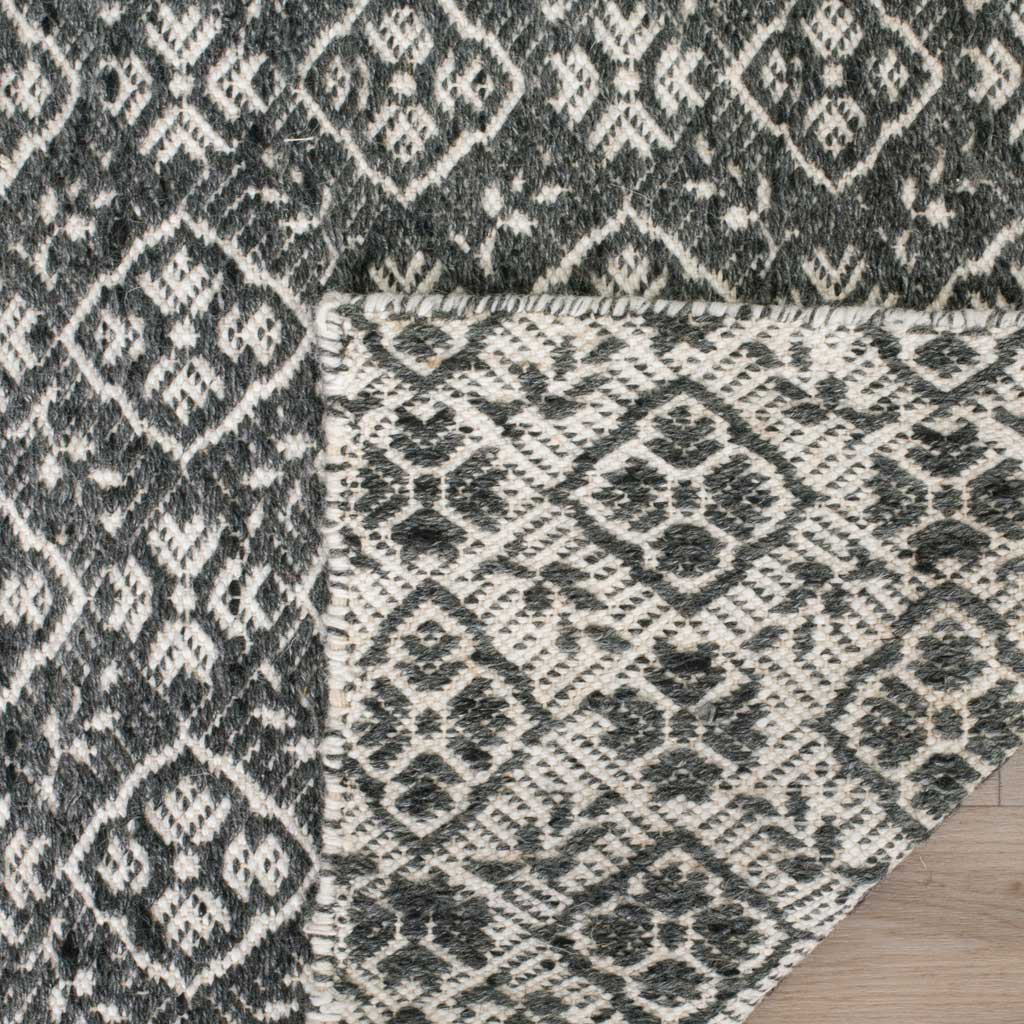 The woven reverse reveals contrasting charcoal and ivory diamond motifs