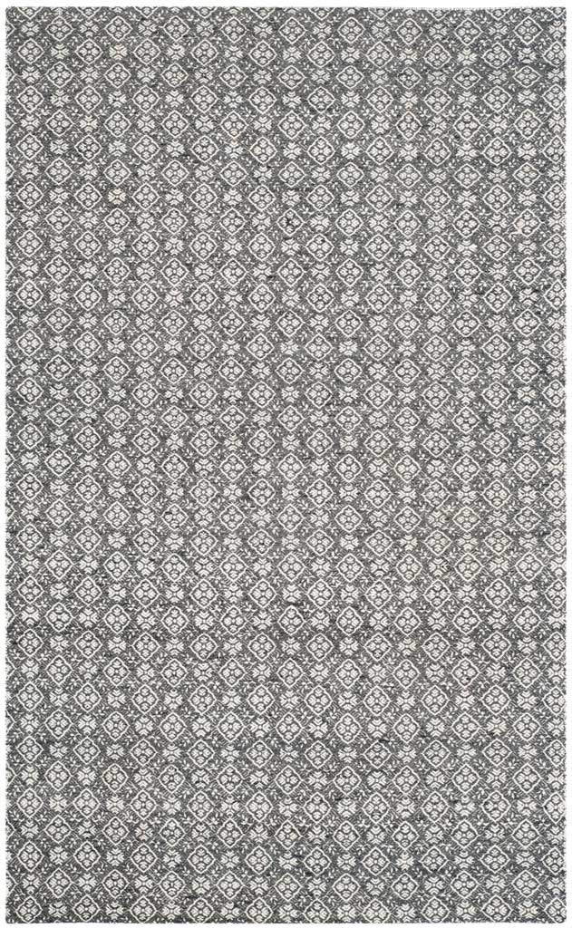 A charcoal wool rug is densely patterned with ornate ivory diamonds and floral details