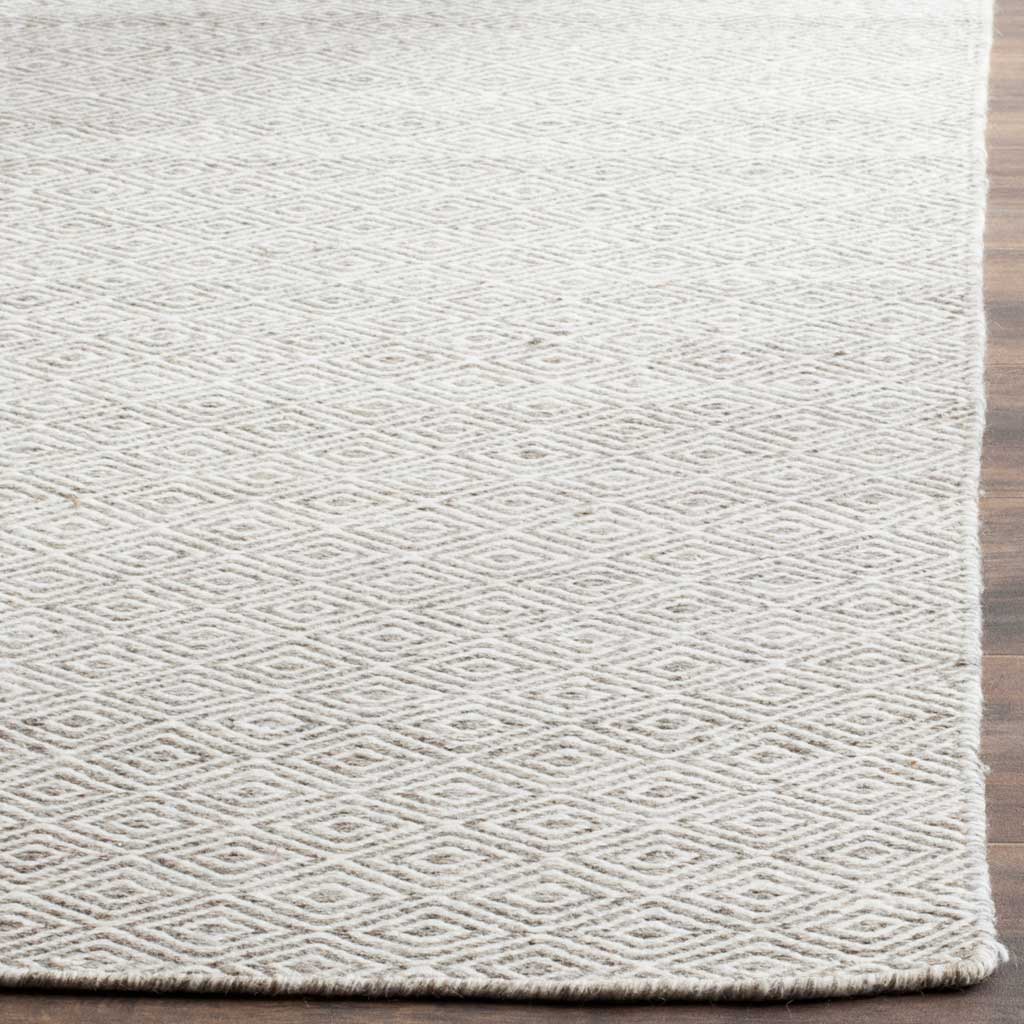 Tightly woven diamond motifs meet neatly finished edges in ivory and graphite wool