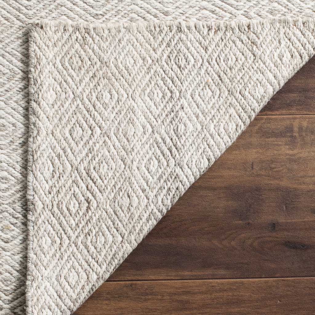 The woven reverse displays textured ivory and silver diamond motifs