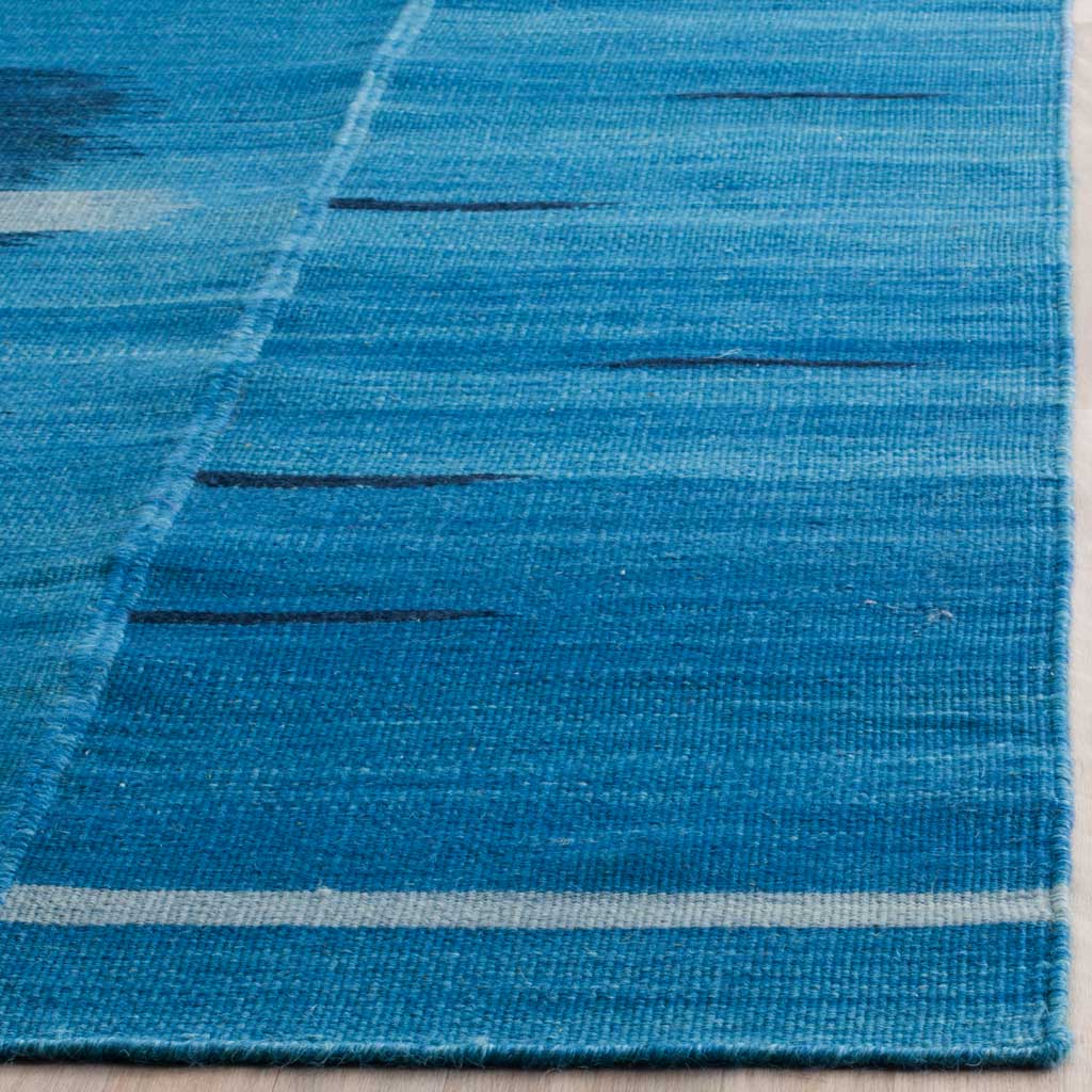 Blue wool weave features fine navy dashes, a slim ivory stripe, and a neatly finished edge.