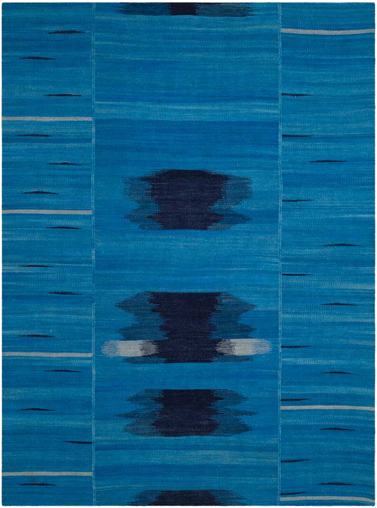 Rectangular blue wool rug blends dark abstract shapes with pale linear accents.