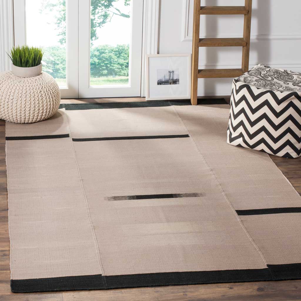 Gray wool rug brings graphic black stripes and soft texture to an airy living space