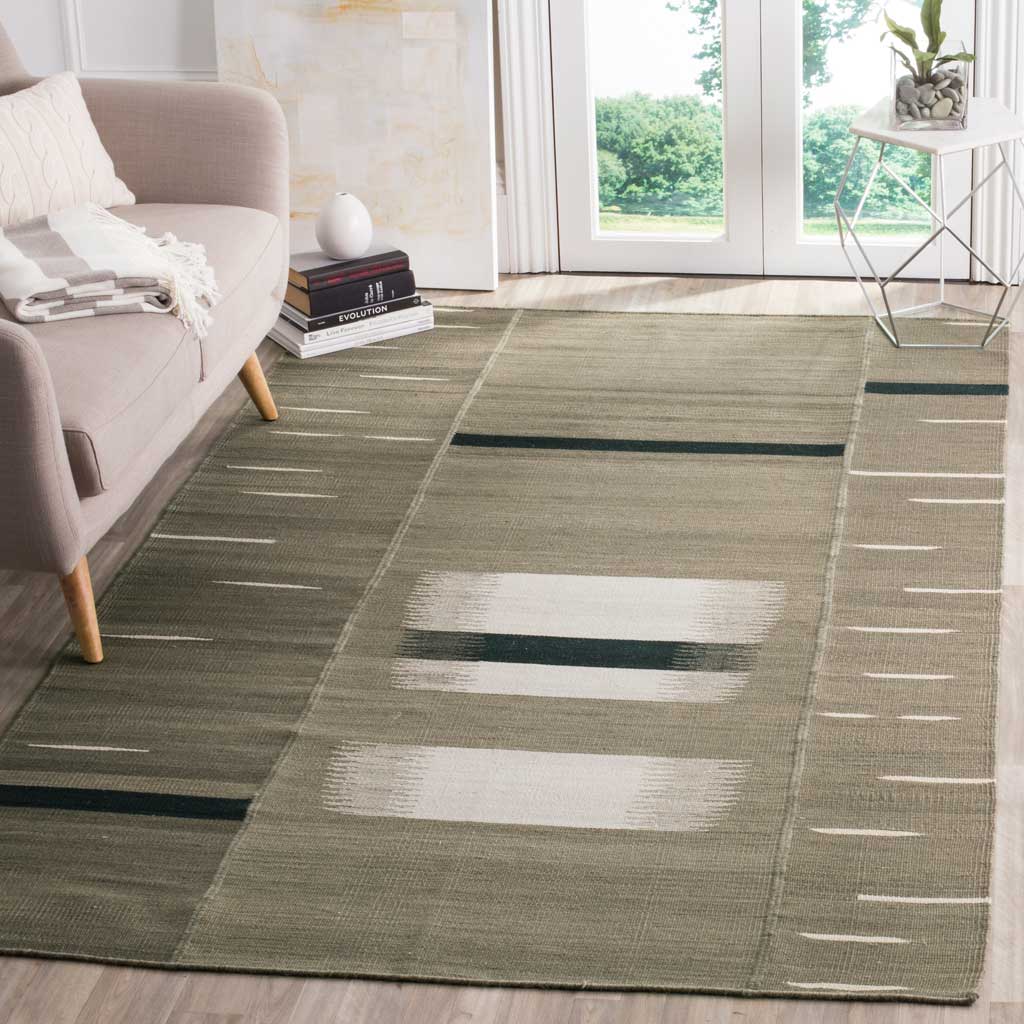 Neutral geometric rug grounds a bright living space with ivory bands and bold dark stripes