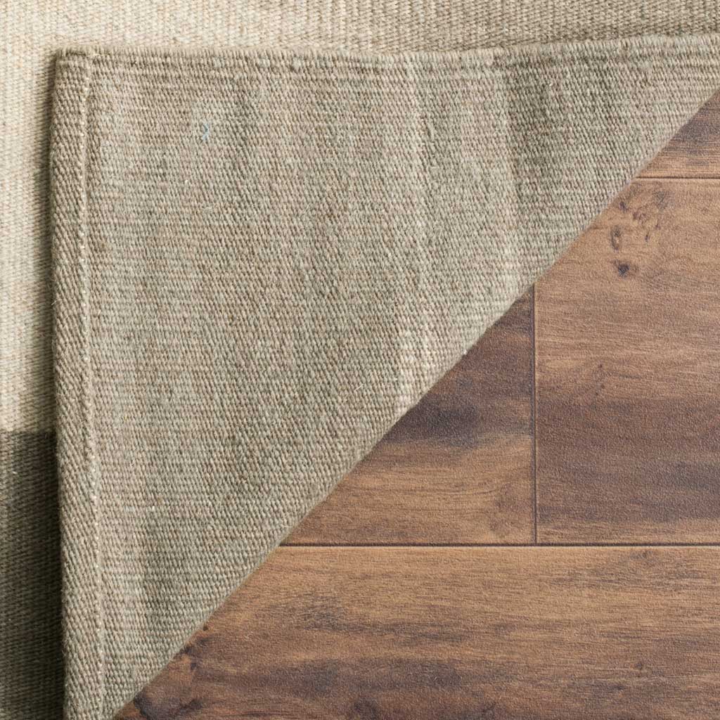 The folded wool rug reveals its woven underside and neatly finished edges
