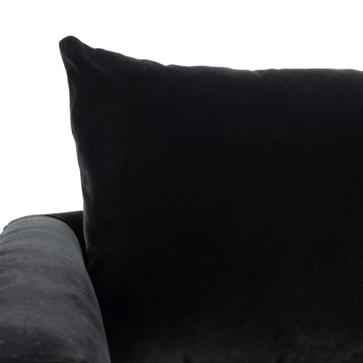 Soft black velvet covers the plush back pillow and gently rounded, cushioned arm