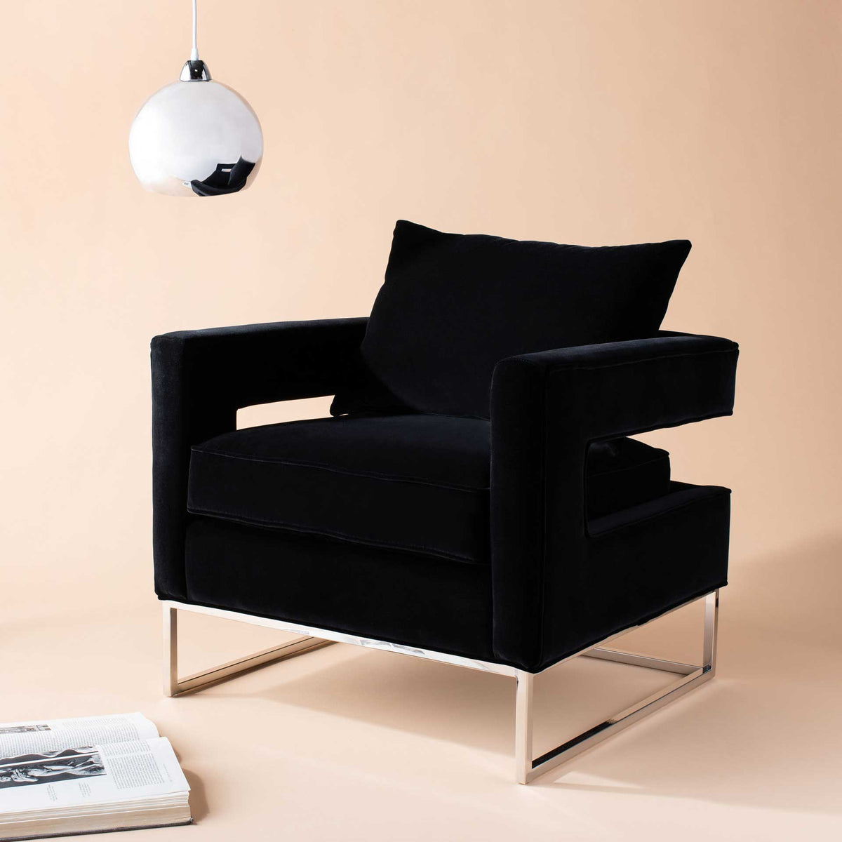 Black velvet upholstery and a sculptural cutout design add modern elegance to a warm living space