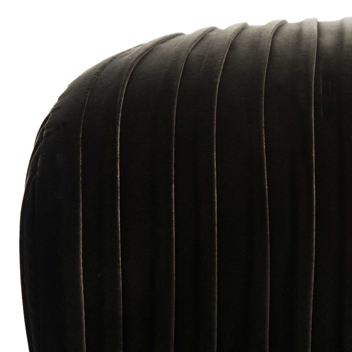 Plush dark gray velvet pleats wrap around the bench's softly rounded edge