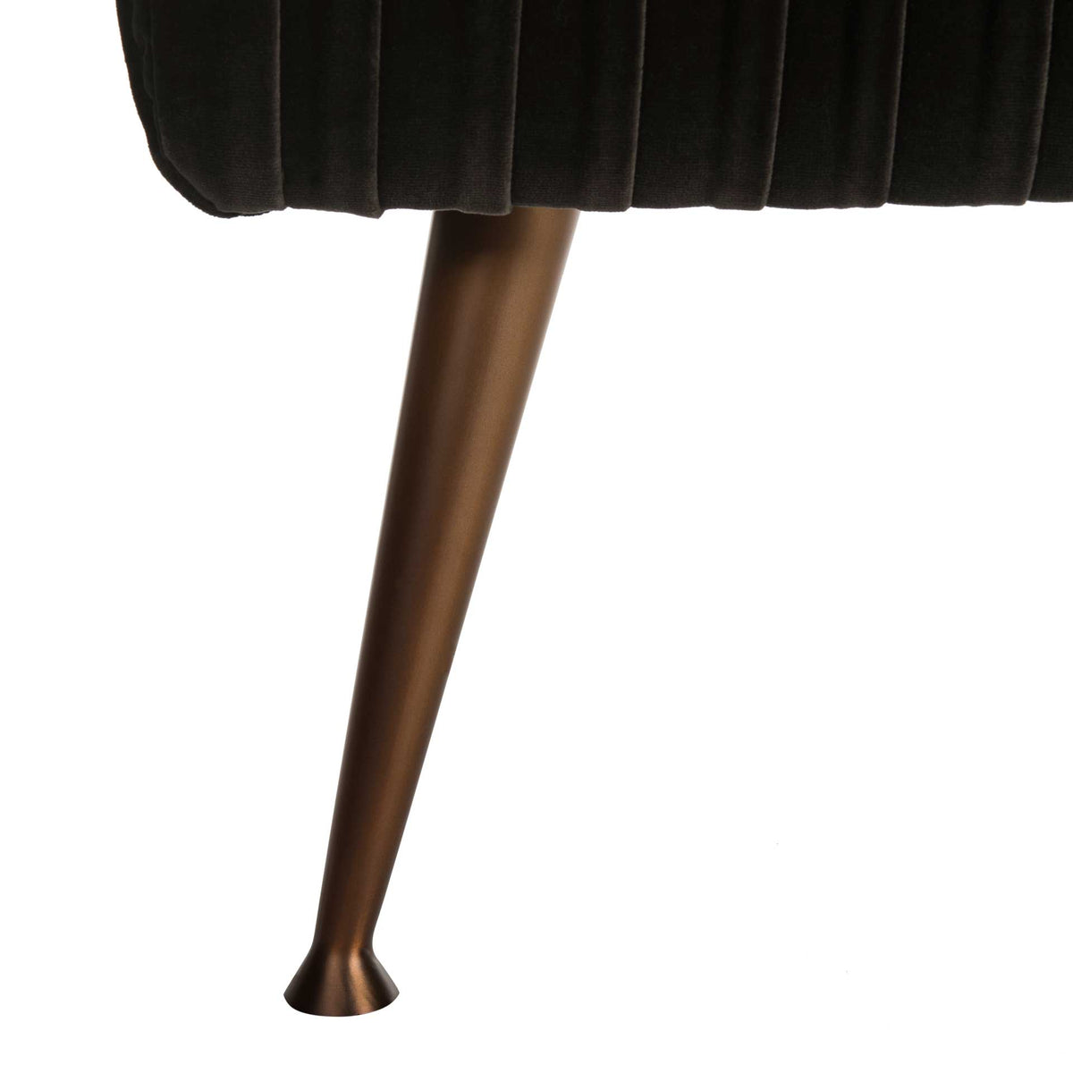A tapered antique brass-finish leg flares at the foot below dark gray velvet upholstery