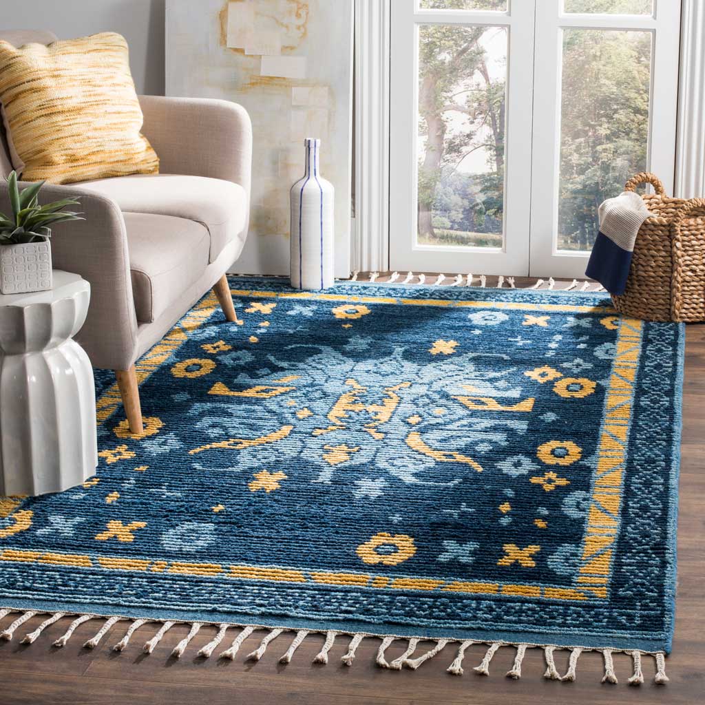 Deep blue and gold motifs and cream fringe add warmth to a bright living space