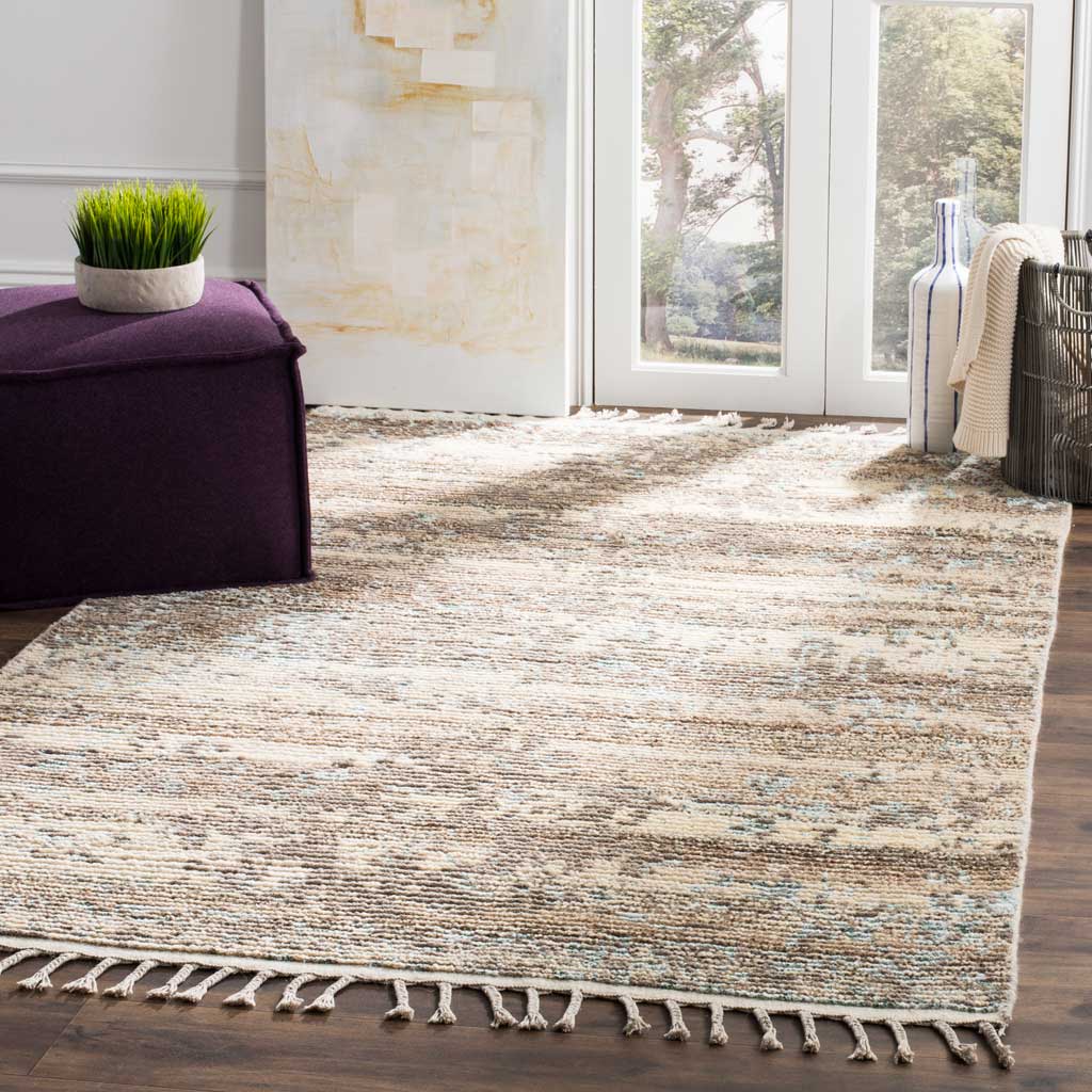 Soft beige and silver pattern adds warmth to a bright living space, with fringe along the rug's edge