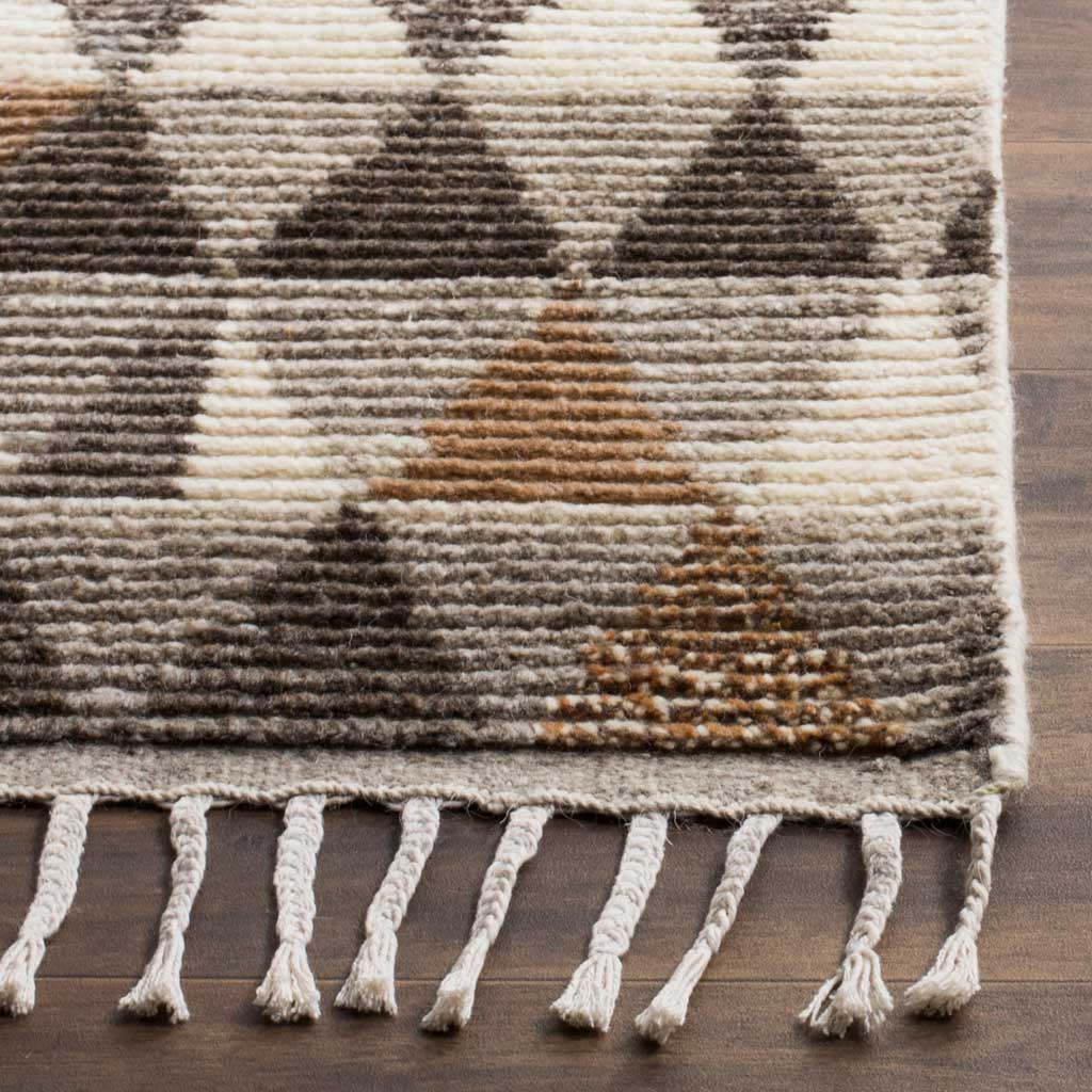 Hand-knotted texture, earthy tones, and twisted fringe give this rug artisanal character