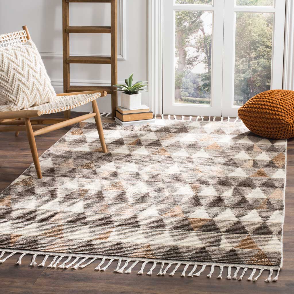 Earth-toned triangle motifs and tasseled fringe bring warmth to a bright living space