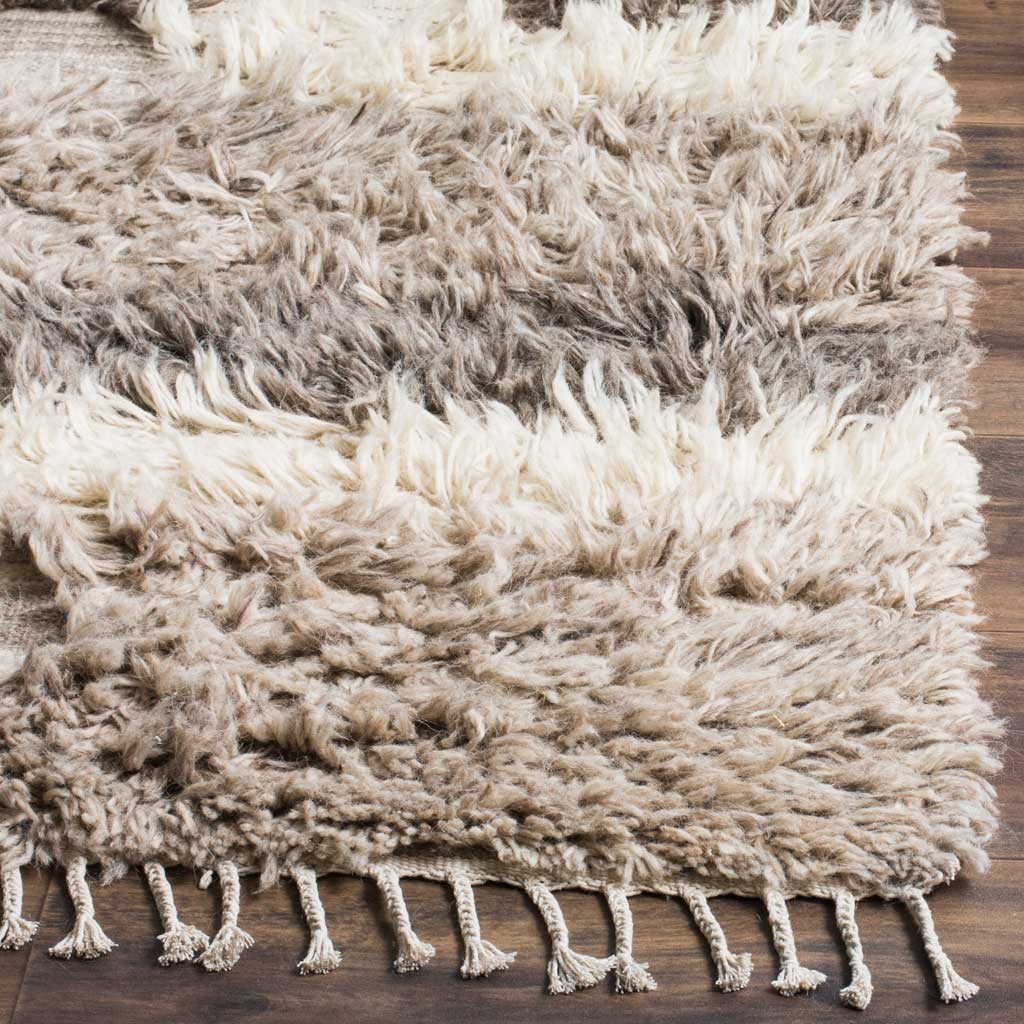 Plush ivory and gray pile meets fine woven bands and tasseled fringe