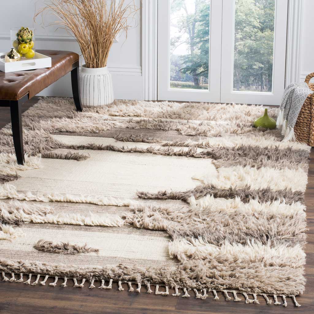 Textured ivory and gray rug adds soft abstract contrast to a bright living space