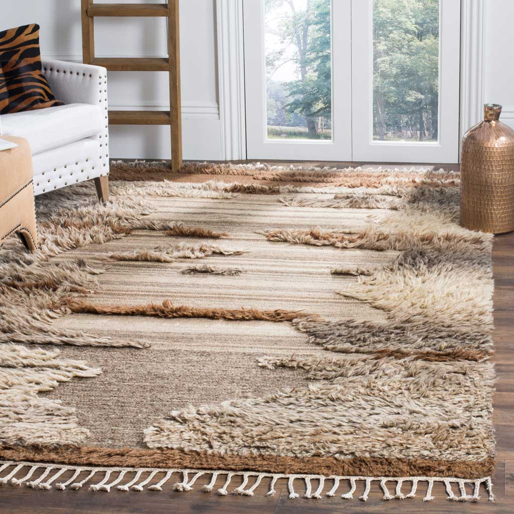 Earthy cream, gray, and brown bands add cozy texture, finished with knotted fringe.