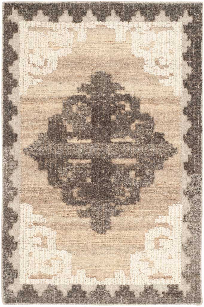 Compact brown rug with a charcoal center motif, ivory corner scrolls and a jagged border