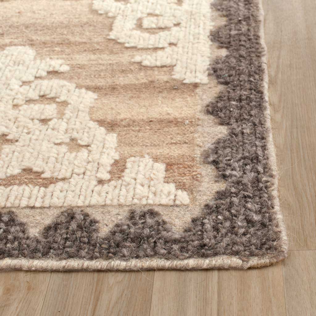 Textured pile and a neatly bound edge frame the contrasting charcoal and ivory design