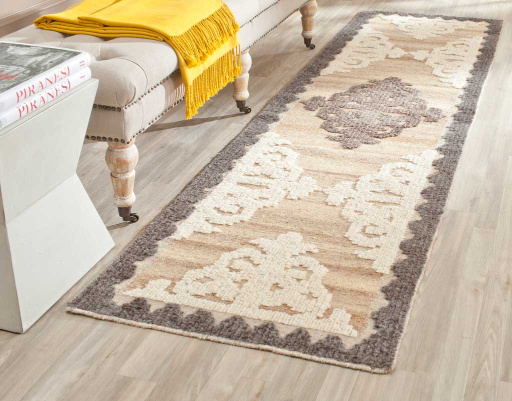 Brown and charcoal runner with ivory scrollwork brings timeless pattern to a light wood floor