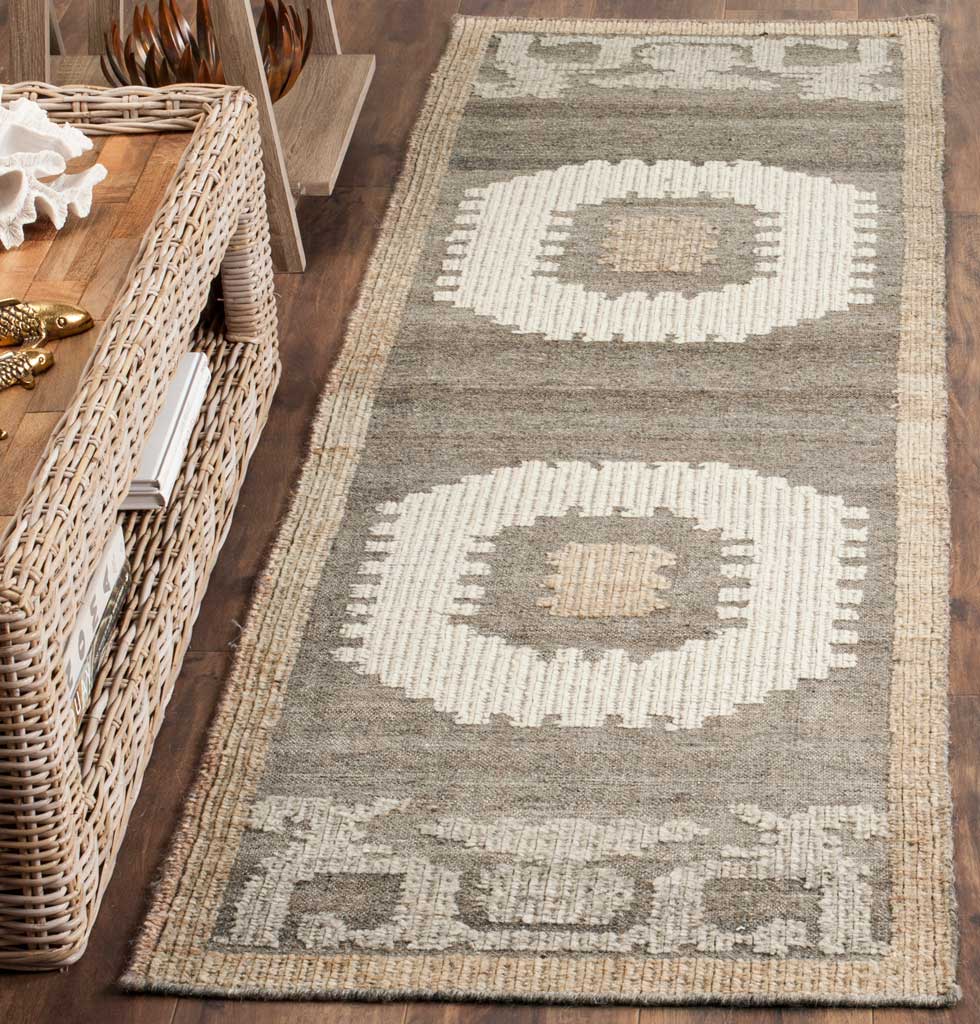 Hand-knotted wool and cotton runner adds graphic ivory motifs and soft texture to a wood-floored space
