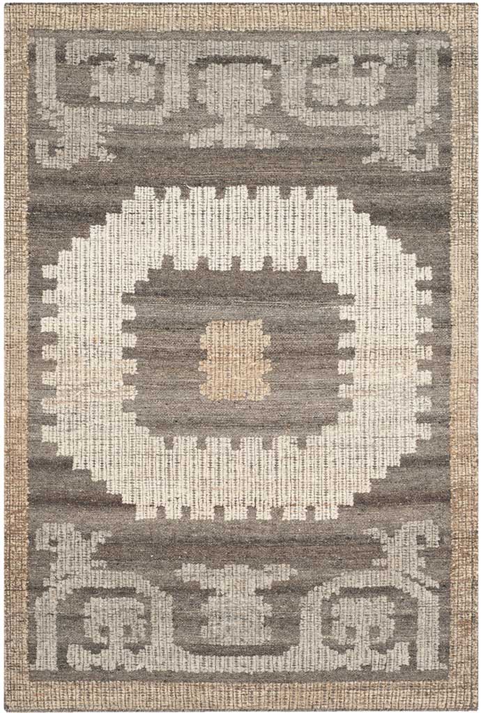 A jagged ivory medallion and tan center add bold contrast to this brown rug with stylized end motifs