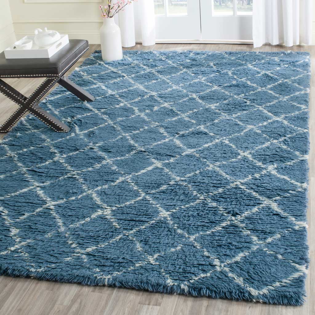Blue rug with an ivory diamond pattern brings plush texture to a bright living space