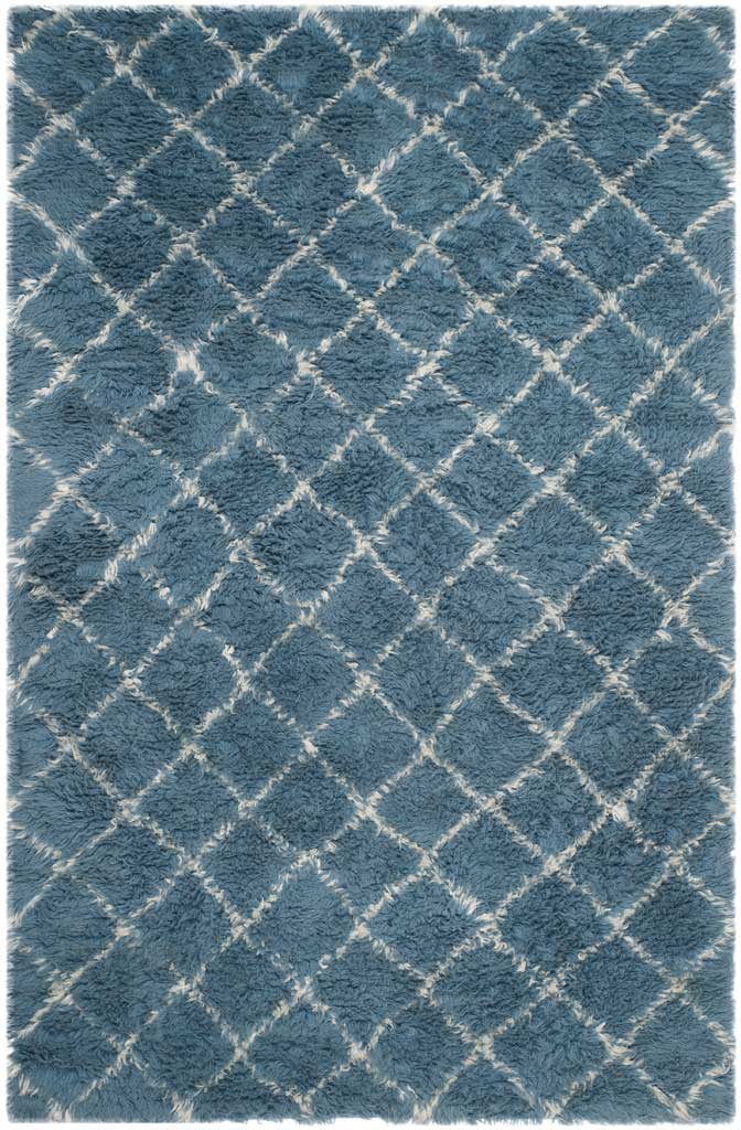 Plush blue rug traced with irregular ivory diamonds across its surface