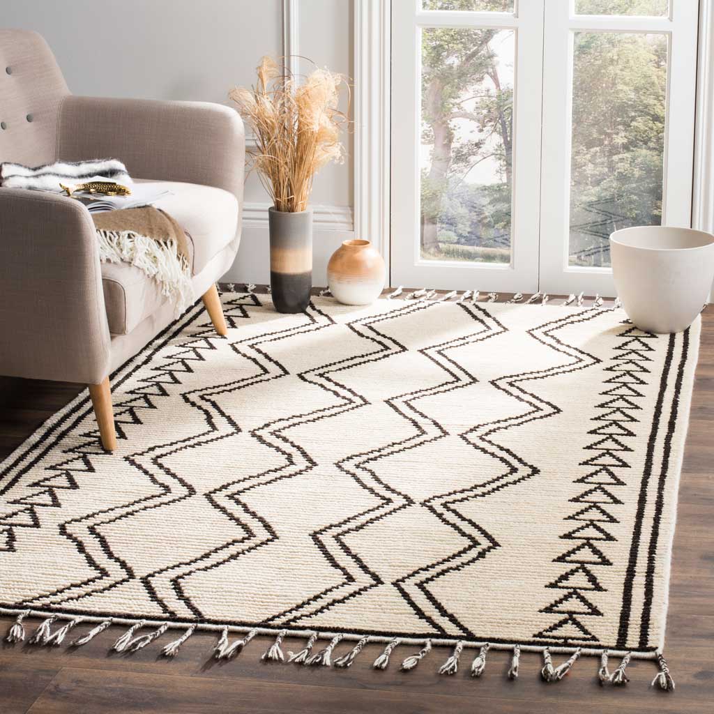 A fringed ivory rug brings a striking black geometric pattern and cozy texture to the living room