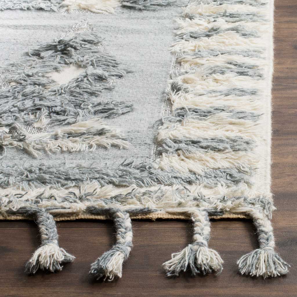 Raised gray and ivory yarns define a striped border finished with thick braided tassels