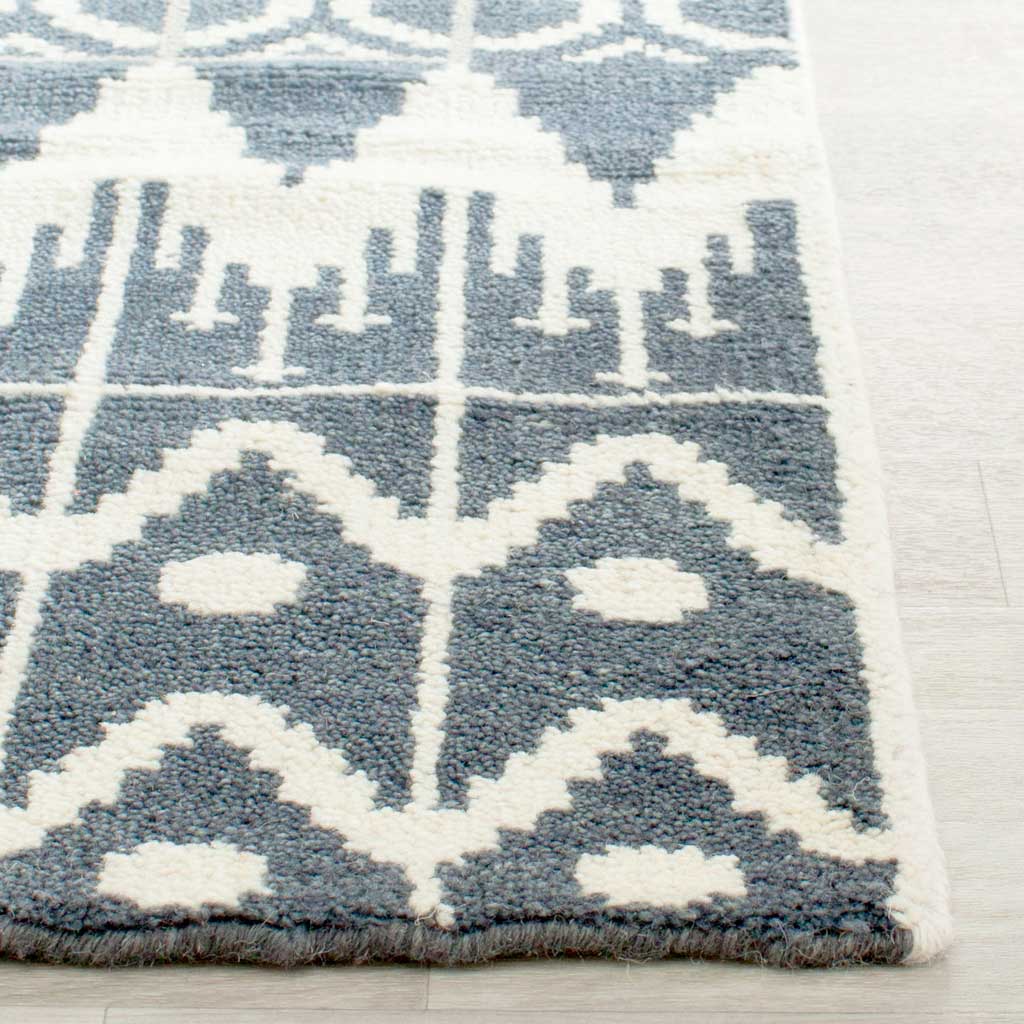 Textured charcoal and ivory geometric pattern meets a neatly finished rug edge