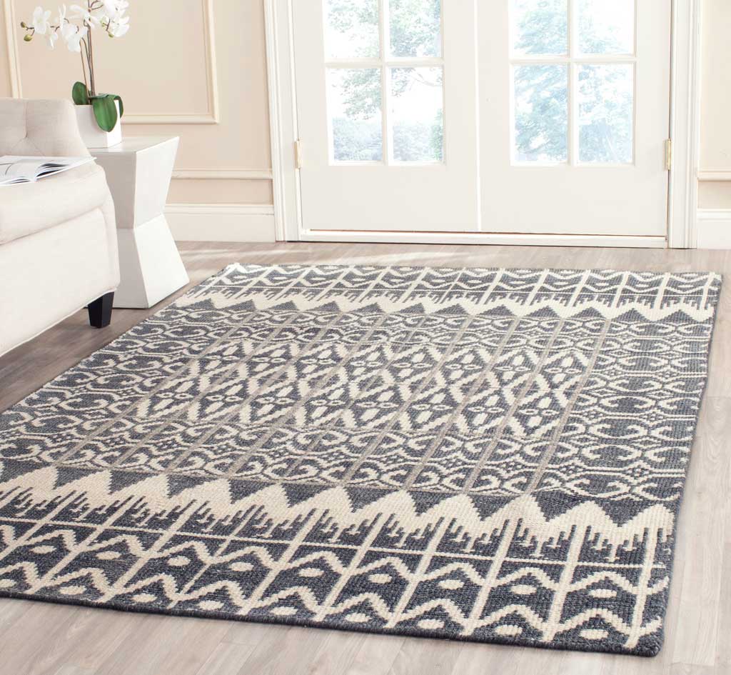Charcoal and ivory geometric patterns lend a welcoming, textured feel to a bright living space