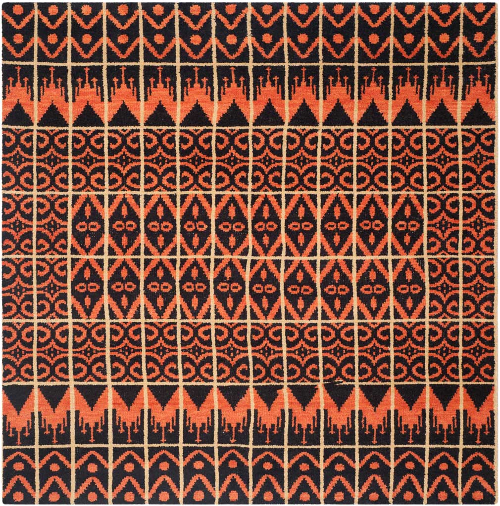 Bold orange zigzags and repeating diamond motifs bring graphic warmth to a square black rug.
