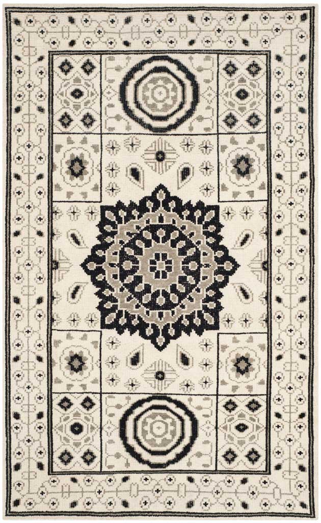 Ivory and gray rug with dark medallions, floral motifs, and an elaborately patterned border
