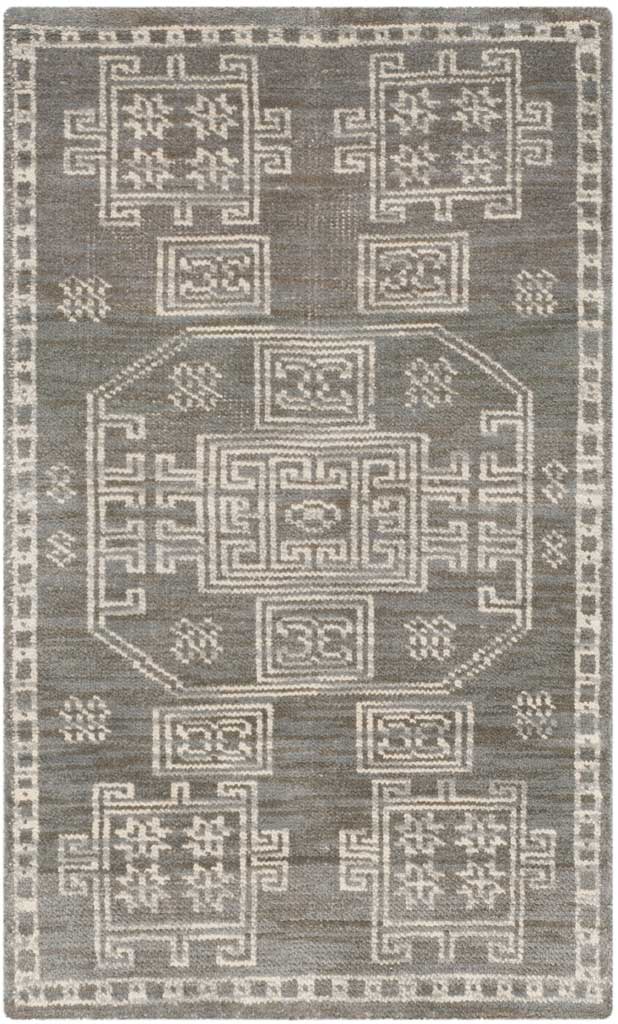 Small gray rug with a central geometric motif and symmetrical ivory accents