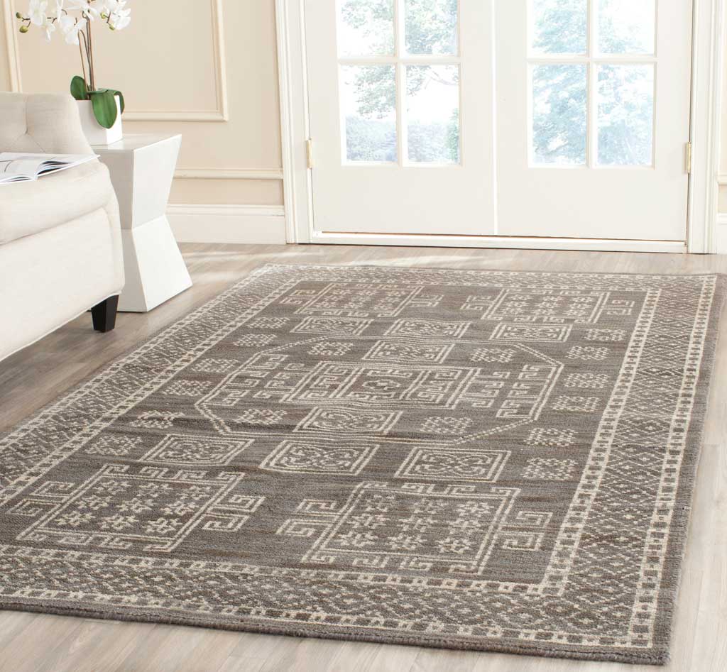 Hand-knotted gray rug with ivory medallions and a patterned border that warms a bright room